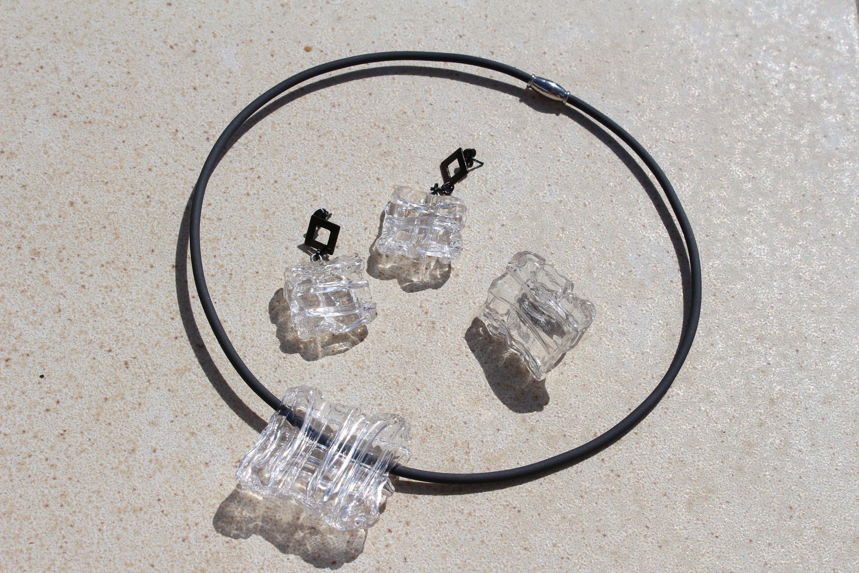 Black and transparent clear jewelry, necklace, ring or earrings made of rubber, "crumpled" acrylic and metal
