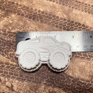 3" plaster monster truck magnet with flames on the side.