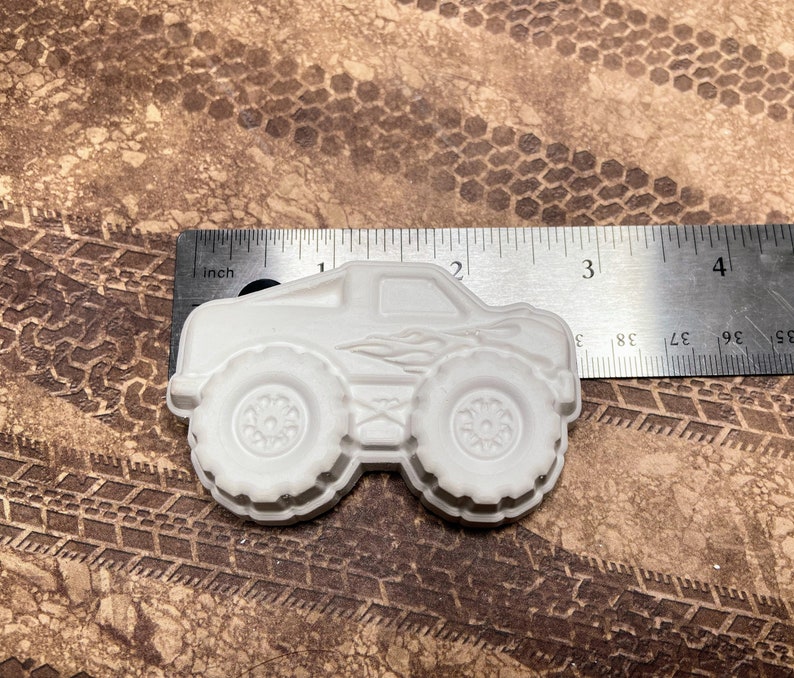 3" plaster monster truck magnet with flames on the side.