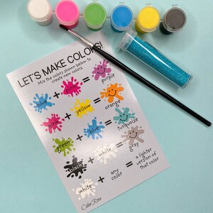 May include: A silver card with the text "Let's Make Colors!" and instructions on how to mix colors to create new colors. The card is surrounded by paint pots in various colors, a paintbrush, and a container of glitter.