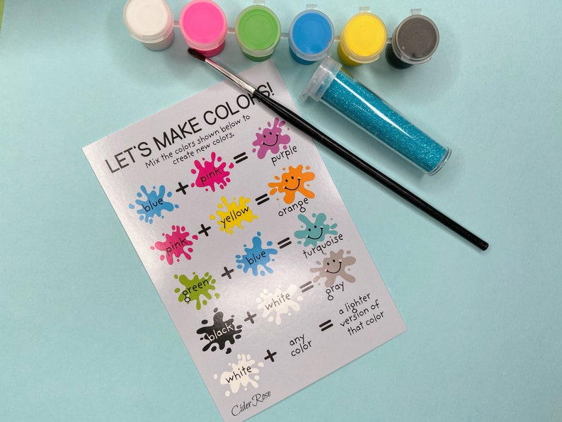 May include: A silver card with the text "Let's Make Colors!" and instructions on how to mix colors to create new colors. The card is surrounded by paint pots in various colors, a paintbrush, and a container of glitter.