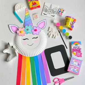 Assortment of unicorn items in craft kit. Paper plate craft, unicorn canvas, unicorn magnet, puzzle, paint set, paint brush, unicorn cookie cutter, crayons, play dough, glue, color scratch picture frame, scissors and unicorn temporary tattoo.