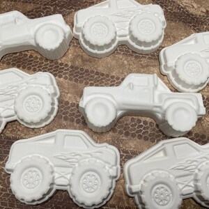Group of large plaster paint your own monster truck magnets.