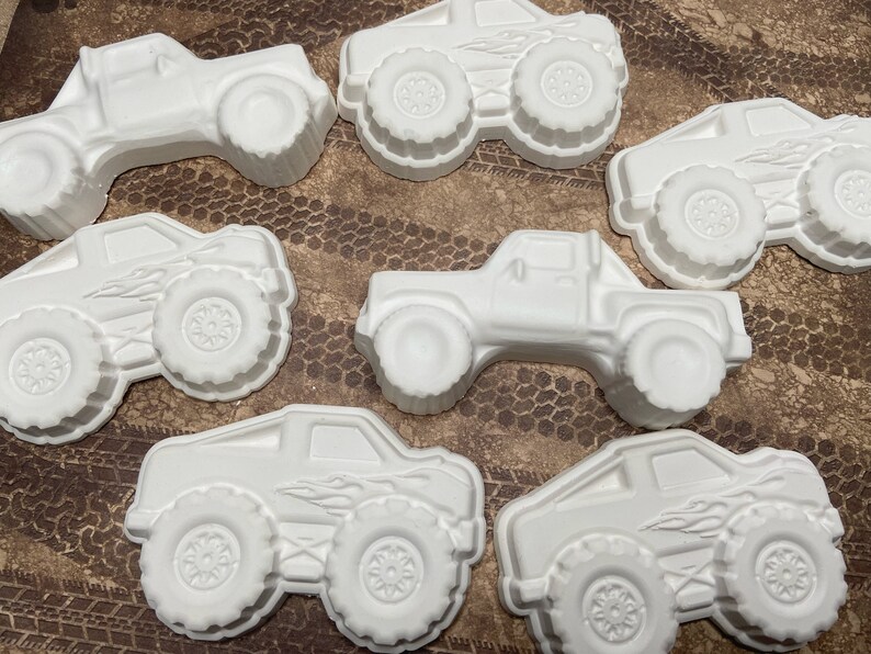Group of large plaster paint your own monster truck magnets.