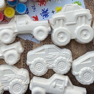 May include: A set of eight white ceramic monster trucks and pickup trucks for painting. The trucks are ready to be decorated with paint and are a fun craft project for kids.
