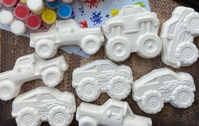 May include: A set of eight white ceramic monster trucks and pickup trucks for painting. The trucks are ready to be decorated with paint and are a fun craft project for kids.