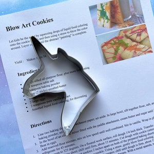 Metal unicorn head cookie cutter with sugar cookie recipe.