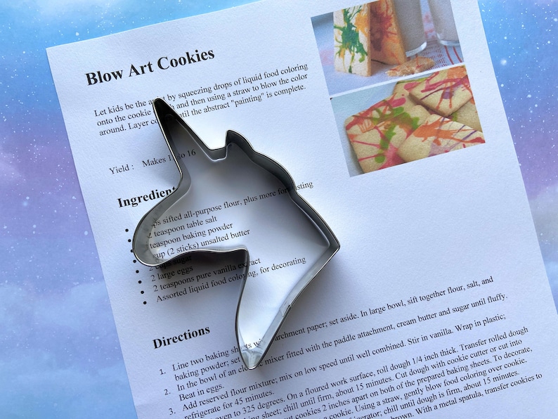 Metal unicorn head cookie cutter with sugar cookie recipe.