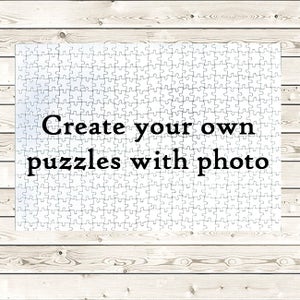 May include: A white jigsaw puzzle with the text "Create your own puzzles with photo" on it.