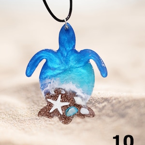 May include: A blue resin turtle pendant necklace with a white seashell and starfish design. The pendant is on a black cord.