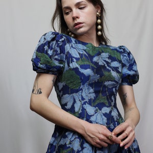Vintage corset style dress with floral print, pleated bottom and puff sleeves