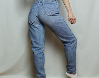 May include: A pair of light blue high-waisted jeans with a brown leather patch that says "Lee" on the back.