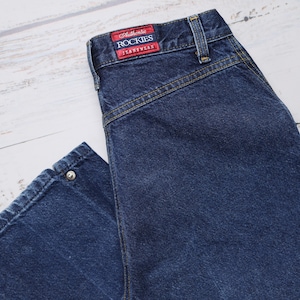 Jeansy ROCKY MOUNTAIN z rozcięciem u dołu W28 L34 Ciemnoniebieskie, Y2K Jeansy ROCKY MOUNTAIN w stylu western z odkrytymi plecami i wysokim stanem