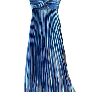 May include: A strapless, floor-length blue dress. The bodice features a twisted design, and the skirt is pleated. The dress is made of a shiny, silky material. The dress is a formal wear item.