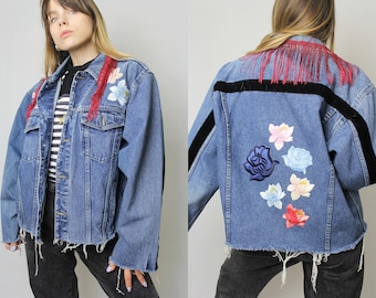 Frayed denim jacket with flower patches and fringed collar