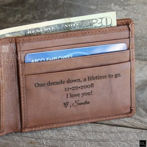 May include: A brown leather wallet with a personalized inscription that reads "One decade down, a lifetime to go. 11-22-2008 I love you! &hearts;, Sandra".