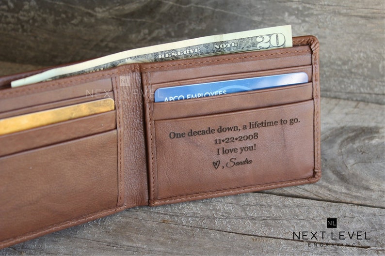 May include: A brown leather wallet with a personalized inscription that reads "One decade down, a lifetime to go. 11-22-2008 I love you! &hearts;, Sandra".