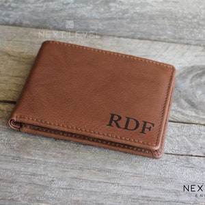 May include: A brown leather wallet with the initials "RDF" embossed on the front.