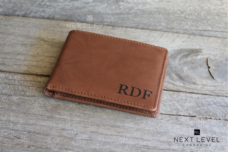 May include: A brown leather wallet with the initials "RDF" embossed on the front.