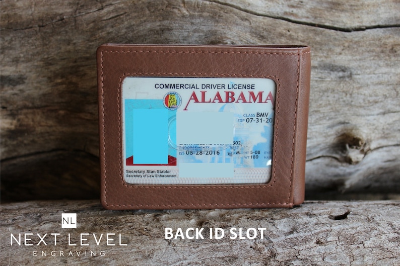 May include: A brown leather wallet with a clear plastic window for displaying an ID card. The window shows a commercial driver's license from Alabama. The text on the license reads "COMMERCIAL DRIVER LICENSE ALABAMA CLASS BMV EXP 07-31-20 Secretary Stan Stabler Secretary of Law Enforcement 302 05-28-2016 5-08 WT 160". The wallet has a back ID slot.