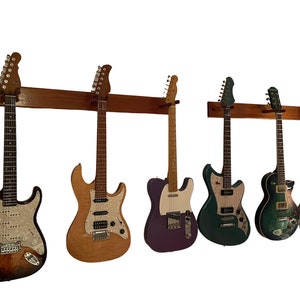 Wall Mount Guitar Holders, For Acoustics, Electrics, and Banjo Available as Single, Double or Triple Mount. Free Shipping in Contiguous USA
