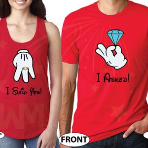 May include: Red tank top with a white Mickey Mouse hand wearing a ring and the text "I Said Yes!" and a red t-shirt with a white Mickey Mouse hand holding a blue diamond ring and the text "I Asked!"