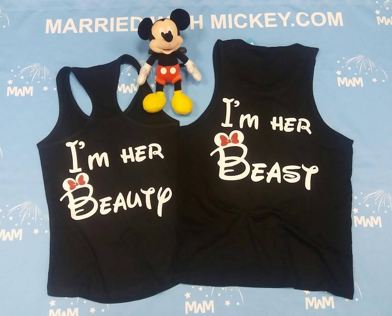 May include: Two black tank tops with white text that says "I'm her Beauty" and "I'm her Beast" with a red bow on the "B".