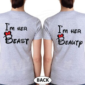 May include: Two gray t-shirts with black text and a red bow. The text on the left shirt reads "I'm her Beast" and the text on the right shirt reads "I'm her Beauty".