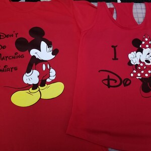 May include: Red t-shirt with Mickey Mouse and the text "I Don't Do Matching Shirts". Red tank top with Minnie Mouse and the text "I Do".