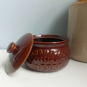 May include: A brown ceramic jar with a lid, featuring the text "Thorntons Special Toffee".