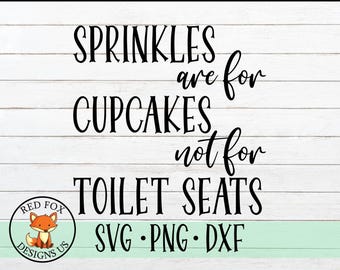 May include: Black and white text on a woodgrain background reads "Sprinkles are for cupcakes not for toilet seats" with a red fox logo that says "Red Fox Designs US" below the text.