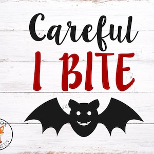 May include: A Halloween-themed graphic on a white wooden background. The text "Careful I BITE" is in black and red. A black bat with a smiling face is below the text. A logo with a fox is in the lower left corner.