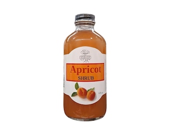 May include: A clear glass bottle filled with orange apricot shrub liquid. The white label features the text Finger Lakes Harvest, Apricot Shrub, and 8 fl. oz. with an illustration of two orange apricots with green leaves on the front.
