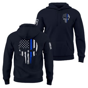 May include: Navy blue hoodie featuring a distressed skull design with the American flag and a blue line. The hoodie has a front pocket and a hood. The design is on the front and back of the hoodie. The hoodie has a logo on the sleeve.
