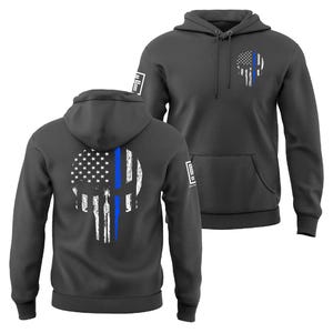 May include: Two charcoal gray hoodies with a distressed skull design. The skull is a combination of the American flag and a blue line. The hoodies have a front pocket and a hood. The design is on the front and back of the hoodies.