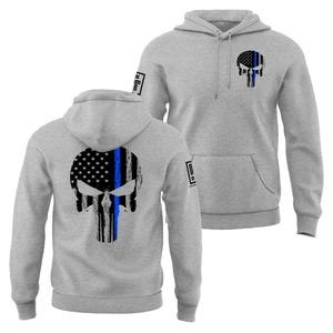 May include: Two gray hooded sweatshirts with a skull design. The skull is a combination of the American flag and a blue line. One sweatshirt has the design on the back, and the other has it on the front. Both sweatshirts have a front pocket and a hood.