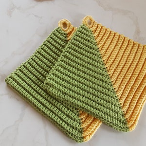 May include: Two crocheted pot holders, one green and one yellow, with a diagonal split between the colours.