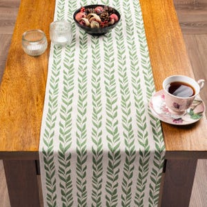 Runner da tavola in misto lino con motivo a righe a foglie di tiglio, colore verde felce. Stile botanico. Decorazione per la tavola di una cena elegante. Disponibile in tre misure.