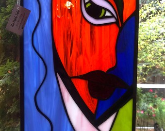 Abstract woman (#1) size is 9 by 13.5, orange and blue abstract glass, unique glass art, modern glass art, cool glass, glass woman’s face