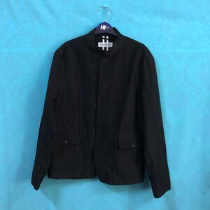 May include: A black blazer with a mandarin collar and two front pockets. The blazer has a single button closure and is hanging on a hanger.