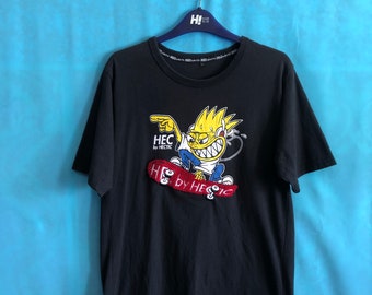 May include: Black t-shirt with a cartoon character skateboarding and the text "HEC by HECtic".