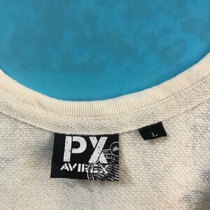 May include: A white tag with black text that reads "PX Aviator" and a size tag that reads "L".