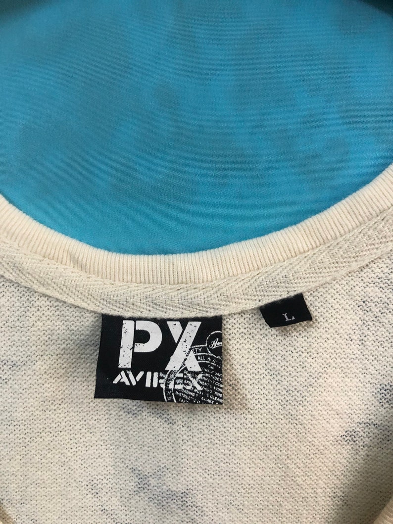 May include: A white tag with black text that reads "PX Aviator" and a size tag that reads "L".