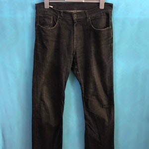 May include: A pair of dark wash denim jeans with a straight leg fit.