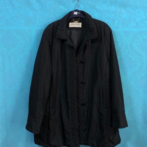 May include: A black Balmain Paris long-sleeved jacket with a quilted design and button closure.