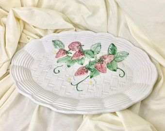 May include: White oval ceramic serving platter with a woven basket design and a raised strawberry motif. The strawberries are painted in shades of pink, red, and green.