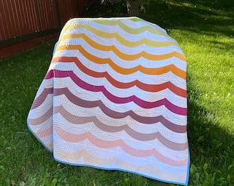 Rainbow coloured lap quilt