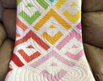 Vibrant rainbow coloured lap quilt