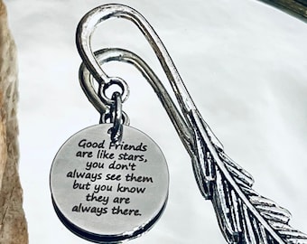 May include: Silver bookmark with a feather design and a round charm that reads "Good Friends are like stars, you don't always see them but you know they are always there."