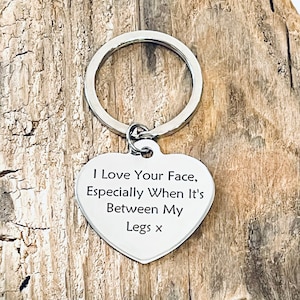 May include: Silver heart-shaped keychain with the text "I love your face, especially when it's between my legs x".